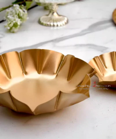 Diwali gift, Small decorative urli, Gold lotus urli, Lotus shaped urli, Metal urli, Decorative metal urli, Gold color urli, Urli for gifting, Wedding gift urli, Decorative gift urli, Gold gift urli, Lotus decoration urli, Urli for hampers, Wedding decor urli, Small gold urli, Lotus urli gift, Gifting metal urli, Decorative gold urli, Lotus candle holder, Potpourri decoration urli, Urli for wax filling, Dry fruit packing urli, Lotus potpourri urli, Decorative candle urli, Small gold lotus urli, Metal lotus urli, Urli with gold finish, Decorative wedding urli, Lotus shaped gift urli, Gold metal urli, Small lotus decor, Wedding favor urli, Decorative centerpiece urli, Lotus shaped candle holder, Gold potpourri urli, Metal lotus candle holder, Lotus wax filling urli, Gift packing urli, Gold lotus decoration, Lotus urli for weddings, Lotus shaped potpourri, Lotus shaped wax urli, Gold decorative urli, Gold lotus candle holder, Metal gold urli, Lotus shaped decorative piece, Small gold decoration urli, Lotus wedding gift, Lotus shaped centerpiece, Urli for dry fruits, Gold gift decoration, Lotus shaped wax holder, Wedding gift packaging, Urli for candles, Small decorative lotus, Gold lotus ornament, Decorative wedding gift, Lotus shaped potpourri holder, Metal lotus wax urli, Lotus shaped decor, Small gold potpourri holder, Wedding gift urli, Lotus candle decoration, Decorative gold lotus, Urli for wax decoration, Lotus urli centerpiece, Gold lotus candle decoration, Small gold wedding gift, Lotus shaped gift packaging, Decorative lotus wax holder, Gold metal decoration, Urli for decorative gifts, Lotus shaped metal urli, Small gold lotus candle holder, Gold decorative piece, Urli for wedding decor, Lotus shaped dry fruit holder, Decorative gold metal urli, Lotus candle holder decoration, Small gold lotus decor, Lotus shaped potpourri decoration, Gold wedding decoration, Decorative wax urli, Lotus shaped candle decor, Small decorative wedding gift, Gold potpourri decoration urli, Metal lotus decorative piece, Lotus shaped wax decoration, Decorative wedding centerpiece, Urli for festive decor, Lotus shaped candle gift, Gold metal decorative piece, Lotus shaped wedding decor, Decorative gold wedding gift, Small lotus wax holder, Lotus shaped potpourri gift, Gold decorative candle holder, Urli for potpourri decoration, Lotus shaped gift decor, Small gold gift urli, Candle holder, Tlight, Home Decorative, Hamper Tray, Return Gift, Corporate Gift, Metal Decorative Dry Fruit Packing, Home Decor, Diwali Decorative, h2h, house2home