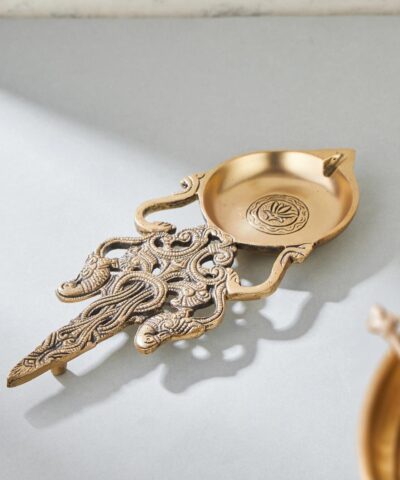 Brass Achmani, Achmani Spoon, Pooja Achmani Spoon, Kapur Aarti Diya, Kapoor Diya, Long Handle Aarti Spoon, Brass Aarti Spoon, Brass Kapoor Dani, Pooja Kapoor Dani, Diya for Aarti, Pooja Essentials Diya, Brass Pooja Essentials, Pooja Thali Items, Kapoor Aarti Spoon, Kapoor Burner Brass, Brass Aarti Diya, Brass Diya for Temple, Traditional Aarti Diya, Pooja Aarti Stand, Diya for Mandir, Brass Diya with Handle, Long Handle Pooja Spoon, Diya Stand Brass, Diya with Long Handle, Aarti Diya for Mandir, Aarti Spoon Brass, Diwali Brass Diya, Diwali Pooja Gift, Diwali Gift Set, Traditional Diwali Gifts, Indian Festival Gifts, Brass Gift Item, Return Gift Brass Diya, Wedding Return Gift, Return Gift for Pooja, Diwali Return Gift, Gifting for Festivals, Brass Gift Hamper, Hamper Gift Ideas, Brass Gift for Housewarming, Housewarming Pooja Gift, Pooja Return Gift Items, Spiritual Gifts for Diwali, Diwali Hamper, Festival Gift Ideas, Traditional Indian Return Gift, Ethnic Return Gifts, Pooja Gift Items, Brass Decorative Diya, Brass Decor Item, Brass Diya Holder, Temple Diya Brass, Mandir Brass Essentials, Brass Pooja Lamp, Handcrafted Brass Diya, Antique Finish Brass Diya, Brass Oil Diya, Decorative Brassware, Brass Handicrafts, Brass Diya for Decoration, Indian Brass Decor, Traditional Brassware, Mandir Decor Items, Brass Pooja Products, Ethnic Brass Items, Vintage Brass Diya, Pure Brass Diya, Brass Items for Gifting, Hamper Gift, Pooja Hamper, Diya Combo Gift, Pooja Set Hamper, Festival Hamper Tray, Religious Gift Hamper, Hamper for Wedding Guests, Hamper Box Items, Festive Gift Set, Gifting Combo for Diwali, Combo Set Brass, Pooja Set Combo, Aarti Kit, Return Gift Combo, Diwali Combo Offer, brass achmani spoon, kapur aarti spoon, लंबी पीतल की आरती चम्मच, पीतल की आचमनी, हाथ से बनी पूजा चम्मच, ब्रास दीपक आरती स्टैंड, दीवाली गिफ्ट आइटम, कपूर रखने की चम्मच, पूजा का चम्मच, पीतल पूजा की वस्तुएं, मंदिर की चम्मच, दीप जलाने की चम्मच, शादी की रिटर्न गिफ्ट, हल्दी कुमकुम गिफ्ट आइटम, हैंडमेड पीतल का आइटम, ब्रास आरती दीपक, हवन समग्री चम्मच, परंपरागत पूजा चम्मच, brass camphor spoon, Indian pooja item, aarti diya handle, ethnic pooja accessories, return gifts for festivals, ब्रास पूजा चम्मच, देवस्थान के लिए चम्मच, South Indian wedding gift, Diwali pooja essentials, pooja thali spoon, brass kapoor holder, भारतीय धार्मिक चम्मच, धार्मिक आयोजन की वस्तु, पूजा सामग्री पीतल, देसी पूजा आरती चम्मच, temple spoon brass, Kapoor Aarti Stand Brass, Indian devotional decor, Deepam Spoon Brass, Kappor Spoon for Mandir
