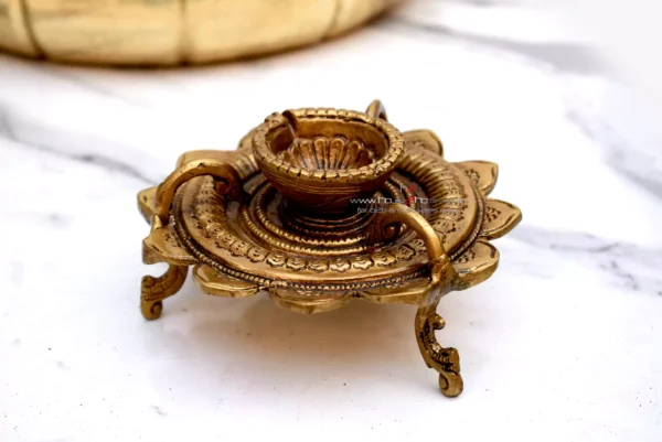 Brass lotus diya, Sanskriti lotus diya, antique brass diya, pooja diya, traditional brass lamp, Indian festival diya, wedding gift diya, diya for home temple, Diwali brass diya, housewarming return gift, Lakshmi pooja diya, handmade diya, lotus shaped diya, decorative brass lamp, diya for mandir, vastu diya, Navratri diya, brass oil lamp, diya for gifting, artisanal diya, Indian decor diya, South Indian brass diya, pure brass diya, pooja essentials, puja diya, brass deepam, spiritual home decor, diya for rituals, handcrafted diya, divine brass diya, temple diya, brass decor piece, diya for aarti, diya with stand, lotus flower diya, vintage diya design, diya set for pooja, Indian brass handicraft, gifting diya, traditional deepak, religious diya, brass deepak, brass diya for Diwali, brass diya India, diya for puja room, diya for Lakshmi pooja, lotus deepak, diya for festive use, diya decoration, diya for temple decor, diya for return gift, diya for pooja room, Indian diya, artisan diya India, diya for Deepavali, kannada deepa, deepam telugu, kannada brass deepa, telugu pooja deepam, diya gift set, diya wedding return gift, diya for Navratri return gift, diya combo set, brass diya bulk order, diya wholesale, decorative diya online, diya pooja item, diya for Indian festivals, diya Diwali decoration, Diwali diya gift, pooja lamp brass, Lakshmi deepam, Krishna pooja diya, diya for prayers, diya Indian traditions, South Indian diya lamp, diya for spiritual use, diya for daily pooja, diya small brass, diya lotus shape, diya for gifting occasions, diya mandir item, Diwali pooja diya, diya for good luck, diya symbol of light, diya positive energy, diya for rituals India, diya handmade India, brass diya 5 inch, brass diya heavy, diya thick base, diya for worship, diya heritage look, diya traditional Indian, Indian spiritual diya, diya in bulk, diya wholesale brass, diya combo gifting, diya handmade India, diya design unique, diya Indian craftsmanship, diya from India, diya from Karnataka, diya from Andhra, diya from Telangana, diya pooja purpose, diya with antique finish, diya glossy look, diya heritage piece, diya pooja collection, diya spiritual feel, diya unique brass, diya lotus motif, diya lotus pattern, diya Indian gift, diya pooja diya, diya South decor, diya wedding pack, diya temple accessory, diya traditional diya, diya Indian theme, diya Indian return gift, diya pure brass finish, diya solid metal, diya auspicious gifting, diya decorative collectible