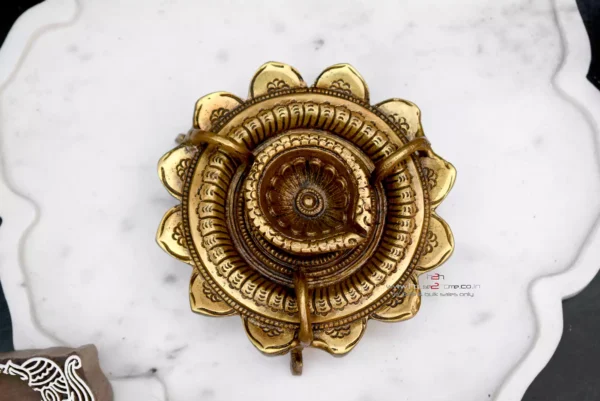 Brass lotus diya, Sanskriti lotus diya, antique brass diya, pooja diya, traditional brass lamp, Indian festival diya, wedding gift diya, diya for home temple, Diwali brass diya, housewarming return gift, Lakshmi pooja diya, handmade diya, lotus shaped diya, decorative brass lamp, diya for mandir, vastu diya, Navratri diya, brass oil lamp, diya for gifting, artisanal diya, Indian decor diya, South Indian brass diya, pure brass diya, pooja essentials, puja diya, brass deepam, spiritual home decor, diya for rituals, handcrafted diya, divine brass diya, temple diya, brass decor piece, diya for aarti, diya with stand, lotus flower diya, vintage diya design, diya set for pooja, Indian brass handicraft, gifting diya, traditional deepak, religious diya, brass deepak, brass diya for Diwali, brass diya India, diya for puja room, diya for Lakshmi pooja, lotus deepak, diya for festive use, diya decoration, diya for temple decor, diya for return gift, diya for pooja room, Indian diya, artisan diya India, diya for Deepavali, kannada deepa, deepam telugu, kannada brass deepa, telugu pooja deepam, diya gift set, diya wedding return gift, diya for Navratri return gift, diya combo set, brass diya bulk order, diya wholesale, decorative diya online, diya pooja item, diya for Indian festivals, diya Diwali decoration, Diwali diya gift, pooja lamp brass, Lakshmi deepam, Krishna pooja diya, diya for prayers, diya Indian traditions, South Indian diya lamp, diya for spiritual use, diya for daily pooja, diya small brass, diya lotus shape, diya for gifting occasions, diya mandir item, Diwali pooja diya, diya for good luck, diya symbol of light, diya positive energy, diya for rituals India, diya handmade India, brass diya 5 inch, brass diya heavy, diya thick base, diya for worship, diya heritage look, diya traditional Indian, Indian spiritual diya, diya in bulk, diya wholesale brass, diya combo gifting, diya handmade India, diya design unique, diya Indian craftsmanship, diya from India, diya from Karnataka, diya from Andhra, diya from Telangana, diya pooja purpose, diya with antique finish, diya glossy look, diya heritage piece, diya pooja collection, diya spiritual feel, diya unique brass, diya lotus motif, diya lotus pattern, diya Indian gift, diya pooja diya, diya South decor, diya wedding pack, diya temple accessory, diya traditional diya, diya Indian theme, diya Indian return gift, diya pure brass finish, diya solid metal, diya auspicious gifting, diya decorative collectible